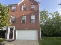 Charming brick home featuring a two-car garage and well-maintained landscaping at 6927 Havenmoor Pl, Indianapolis, IN 46250