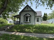 Charming single-story home with inviting front porch and well-maintained lawn on a sunny day at 707 S Harrison St, Alexandria, IN 46001