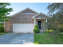 Charming brick home featuring an attached two-car garage and well-maintained landscaping at 8199 Sydney Ln, Avon, IN 46123
