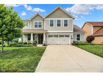 Charming two-story home with a stone facade, well-manicured lawn, and an inviting front entrance at 848 Silverheels Dr, Westfield, IN 46074