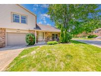 Charming home featuring a well-manicured lawn, brick accents, and a cozy front entrance at 9054 Cornucopia Dr, Indianapolis, IN 46268
