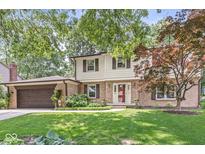 Charming two-story home with a well-manicured lawn and mature trees at 9221 Holyoke Ct, Indianapolis, IN 46268