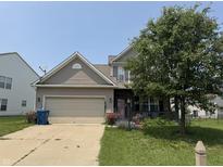 Charming two-story home featuring a two-car garage, manicured lawn, and traditional siding at 9704 Gull Lake Dr, Indianapolis, IN 46239