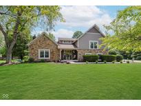 Charming home with stone accents, manicured lawn, and inviting front porch at 102 Roxbury Ln, Noblesville, IN 46062