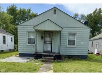 Quaint single-story home with a covered porch and a small front yard needing some TLC at 1030 N Concord N St, Indianapolis, IN 46222