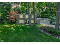 Charming two-story home with attached two-car garage and a lush green front yard at 11510 Ralston Ave, Carmel, IN 46032