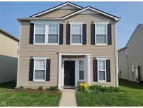 Charming two-story home with a manicured lawn, black shutters, and neutral siding at 12671 Endurance Dr, Fishers, IN 46037