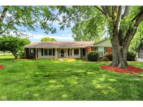 Charming ranch home with a well-maintained lawn and beautiful mature trees at 13172 E 116Th St, Fishers, IN 46037