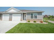 Charming home featuring a one car garage, landscaped front yard, and brick facade at 1452 Coen Ct, Columbus, IN 47201