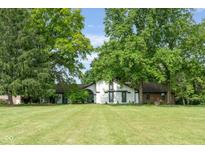Sprawling front yard and two-story home with dark trim surrounded by mature trees at 15812 Joliet Rd, Westfield, IN 46074