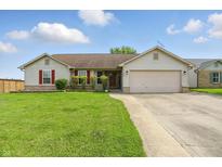 Charming single-story home with a well-manicured lawn and a two-car garage at 2145 W Autumn Ln, Columbus, IN 47201