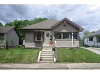 Charming home with a welcoming front porch and well-maintained lawn, featuring beautiful landscaping and a cozy entrance at 29 Home Ave, Markleville, IN 46056