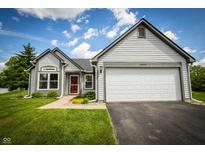 Charming one story home featuring a two car garage, neat landscaping and a red front door at 2905 Inverrary Ct, Indianapolis, IN 46234