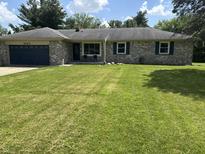 Charming single story brick home with a well-maintained lawn and a two car garage at 4343 W Fairview Rd, Greenwood, IN 46142