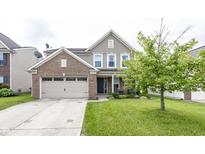 Charming two-story home with a brick and siding exterior, a well-manicured lawn, and an attached two-car garage at 5215 Climbing Rose Pl, Indianapolis, IN 46254