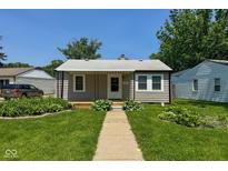 Charming single-story home with well-maintained front yard and covered porch at 5866 Shimer Ave, Indianapolis, IN 46219