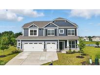 Beautiful two-story home with a three-car garage and manicured lawn, perfect for Gathering living at 6762 Brentwood Ct, Brownsburg, IN 46112