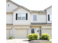 Charming two-story townhome with attached garage, neat landscaping and neutral siding at 7042 Gavin Dr, Indianapolis, IN 46217