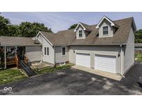 Charming home featuring a two-car garage, dormer windows and neutral-toned siding at 730 N Forsythe St, Franklin, IN 46131