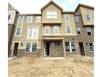 New construction townhome showing brick and siding facade and covered entry at 7305 Bayview Run # 13-605, McCordsville, IN 46055