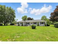 Attractive single-story home with a manicured lawn and tidy landscaping at 8510 N Carroll Rd, Indianapolis, IN 46236