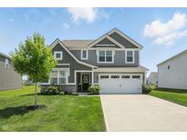 Charming two-story home with a well-manicured lawn and a two-car garage at 9537 Crossfield Rd, Avon, IN 46123