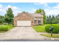 Charming brick home featuring an attached garage, well-manicured lawn, and welcoming curb appeal at 1105 Sarah Ct, Greenwood, IN 46142