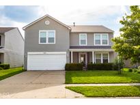 Charming two-story home with a two car garage, well-maintained lawn, and inviting front porch at 2388 Cedarmill Dr, Franklin, IN 46131