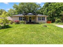 Charming single-story home featuring a covered porch, mature trees, and a lush green lawn at 29 Northview Dr, Danville, IN 46122