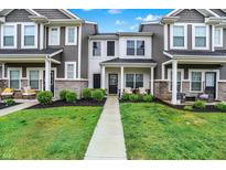 Charming townhome with manicured lawn and inviting front porch, perfect for relaxing outdoors at 3428 Thomas Jefferson St, Westfield, IN 46074