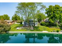 Charming two-story home on the water with mature trees and lush green lawn at 3701 Sandy Hook Dr, Columbus, IN 47203