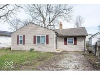 Charming single-story home with neutral siding, red shutters, and a well-maintained front yard at 5050 W Regent St, Indianapolis, IN 46241