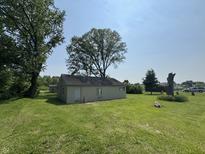 The exterior features a small structure with lawn and trees surrounding it at 5159 E Edgewood Ave, Indianapolis, IN 46237