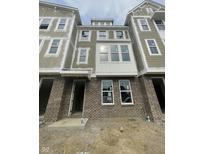 New construction exterior features brick facade, siding, and large windows allowing for natural light at 7309 Bayview Run, McCordsville, IN 46055
