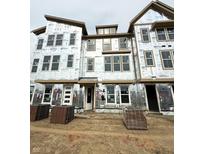 New construction townhome featuring modern design, large windows, and durable exterior materials in a developing neighborhood at 7351 Bayview Run, McCordsville, IN 46055