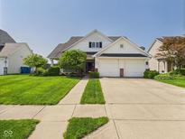 Charming two-story home with a well-manicured lawn, inviting curb appeal, and a two-car garage at 9635 Shasta Dr, Fishers, IN 46038