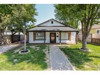Charming single-story home with a gravel path and lush green lawn, framed by mature trees at 110 Highland Ave, Franklin, IN 46131