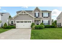 Charming two-story home featuring manicured lawn, flower boxes, attached two-car garage, and tasteful, neutral vinyl siding at 1217 Old Vines Trl, Greenwood, IN 46143