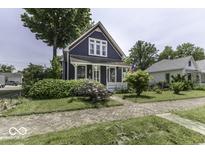 Charming two-story home with a well-manicured front yard, brick driveway, and lovely landscaping at 1393 Wayne St, Noblesville, IN 46060