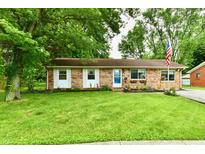 Charming brick home with a well-maintained front yard and lush greenery at 1445 Biloxi Ln, Beech Grove, IN 46107