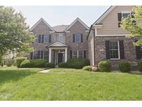 Charming two-story brick home with a well-manicured lawn and neatly trimmed hedges at 15201 Slateford Rd, Noblesville, IN 46062