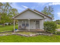 Charming one-story home with covered porch and landscaped front yard at 1535 Whalen Ave, Indianapolis, IN 46227