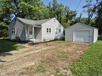 Charming single-story home with a detached garage and driveway at 1584 Shady Ln, Columbus, IN 47201