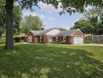 Charming red brick home with a well-manicured front lawn and a convenient attached garage at 1628 Edgewood Dr, Anderson, IN 46011