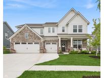 Beautiful two-story home featuring brick and white siding, a three-car garage, and a well-manicured front lawn at 19652 Shadow Trace Path, Westfield, IN 46074