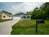 Charming one-story home with a manicured lawn, a two-car garage, and beautiful curb appeal at 2159 W 58Th Nw St, Indianapolis, IN 46228