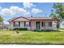 Charming single-story home with red trim, a covered porch, and a well-maintained front lawn at 2908 N Routiers Ave, Indianapolis, IN 46219