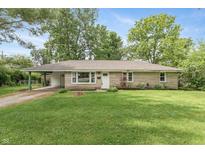 Charming ranch-style home with a well-maintained lawn and a covered carport at 3225 25Th St, Columbus, IN 47203