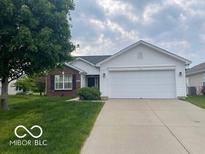 Ranch home with a brick accent, a two-car garage, and a well-manicured lawn at 3861 Indigo Blue Blvd, Whitestown, IN 46075