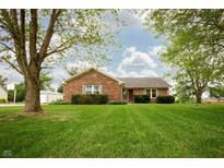 Charming brick ranch home featuring a well-manicured lawn and mature trees at 4901 E County Road 100 N, Avon, IN 46123